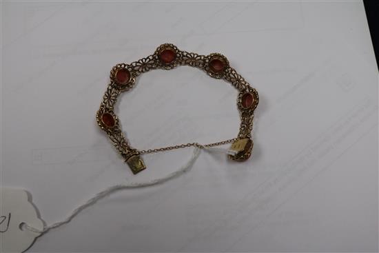 A 9ct gold and cabochon coral set pierced bracelet.